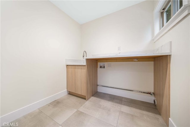 washroom with laundry area, baseboards, light tile patterned floors, and washer hookup