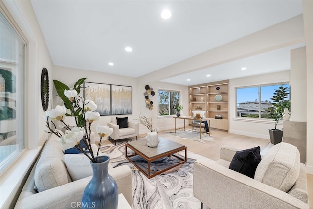 living room featuring baseboards and recessed lighting