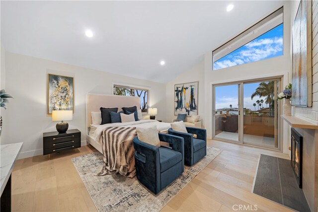 bedroom with high vaulted ceiling, light wood-style flooring, recessed lighting, baseboards, and access to exterior