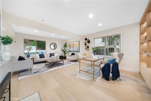 living room featuring a healthy amount of sunlight, baseboards, wood finished floors, and recessed lighting