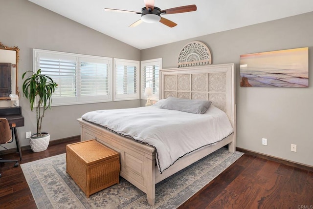 bedroom featuring dark wood-style floors, vaulted ceiling, baseboards, and a ceiling fan