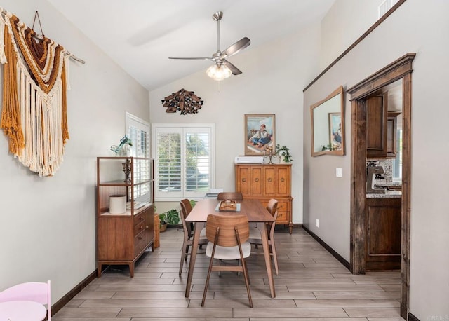 dining area with wood tiled floor, baseboards, vaulted ceiling, and a ceiling fan