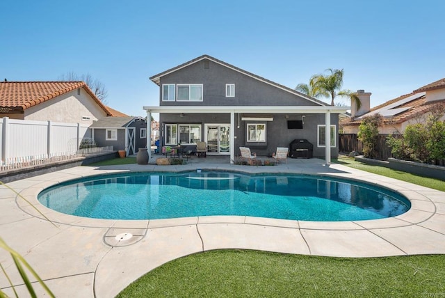 view of swimming pool with a fenced in pool, a fenced backyard, a patio, and area for grilling