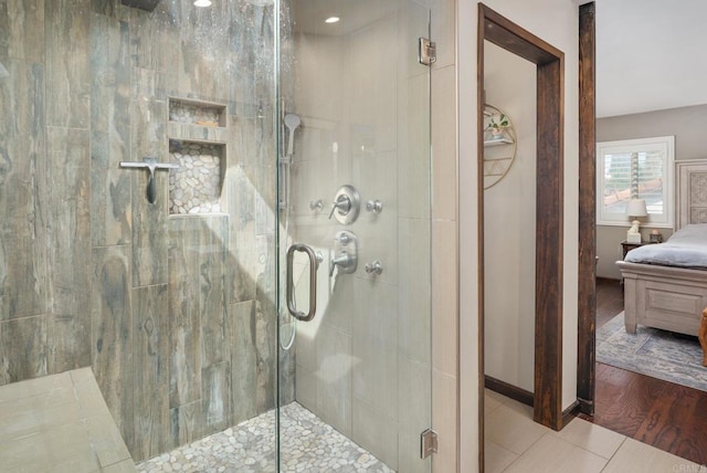 ensuite bathroom featuring a stall shower, tile patterned flooring, and ensuite bathroom