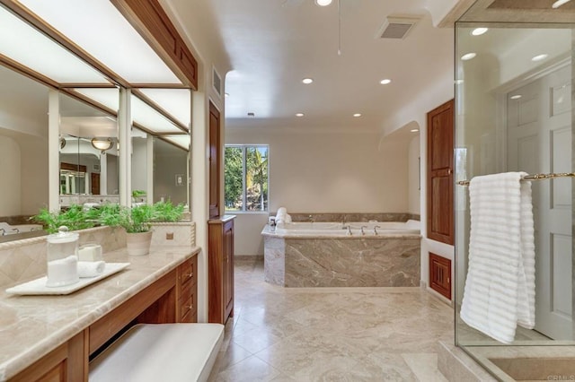 full bathroom featuring visible vents, vanity, a bath, and recessed lighting