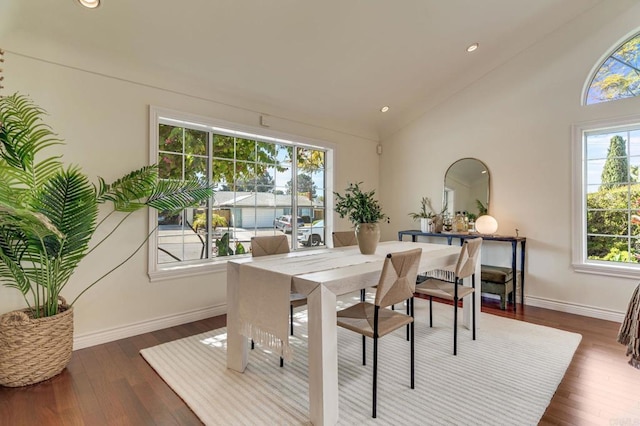 dining area featuring high vaulted ceiling, baseboards, dark wood-type flooring, and recessed lighting