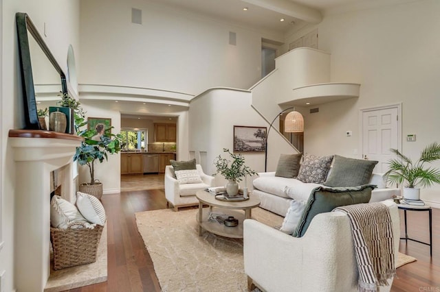 living area with a towering ceiling and dark wood-type flooring