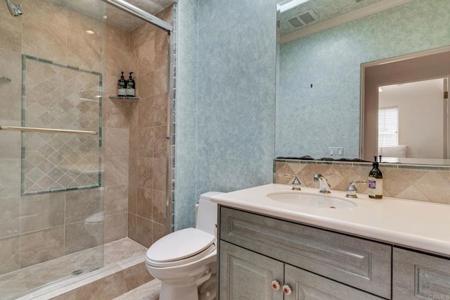 bathroom with toilet, a stall shower, visible vents, and vanity