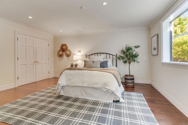 bedroom featuring baseboards, wood finished floors, and recessed lighting