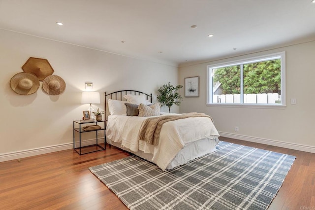 bedroom featuring recessed lighting, baseboards, and wood finished floors