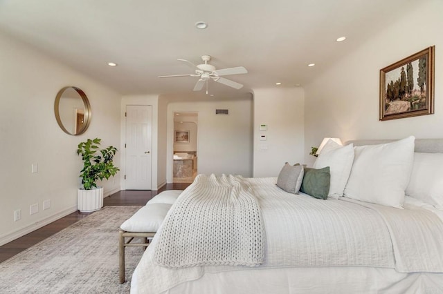 bedroom with baseboards, ensuite bath, dark wood finished floors, and recessed lighting