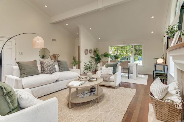 living area featuring high vaulted ceiling, recessed lighting, wood finished floors, visible vents, and beamed ceiling