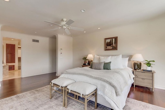 bedroom featuring baseboards, visible vents, dark wood finished floors, and recessed lighting