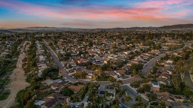 aerial view at dusk with a residential view and a mountain view