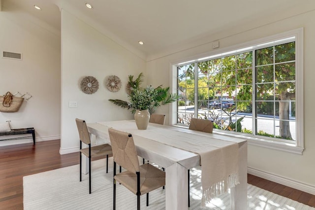 dining area with a wealth of natural light, visible vents, and wood finished floors