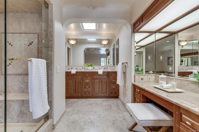 bathroom with a shower stall and vanity