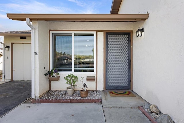 doorway to property with stucco siding