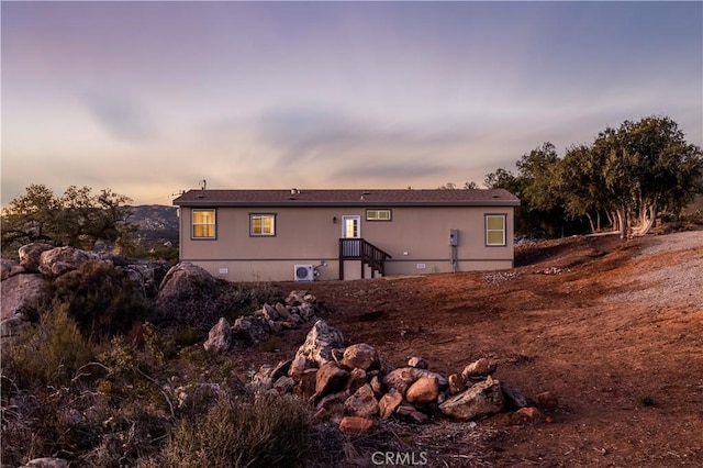 view of back of house at dusk