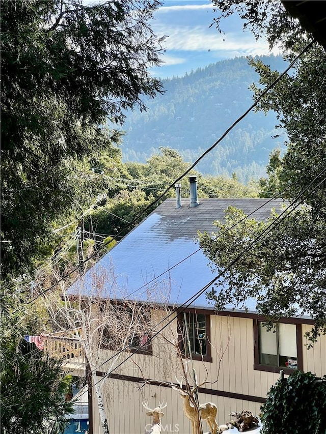 view of side of home with a mountain view