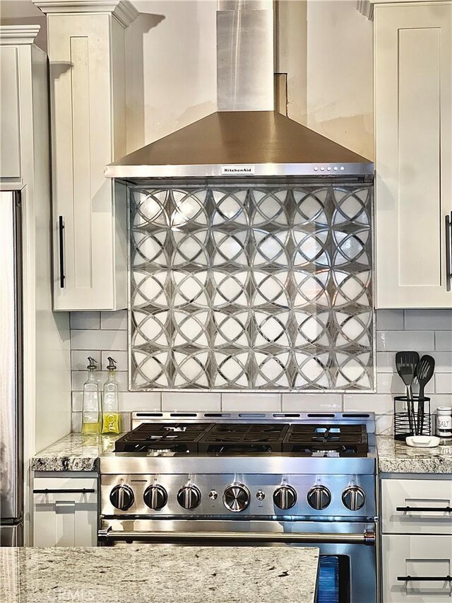 370 Weisshorn Dr, Crestline, CA 92325 - kitchen with wall chimney range hood, tasteful backsplash, stainless steel appliances, and white cabinets