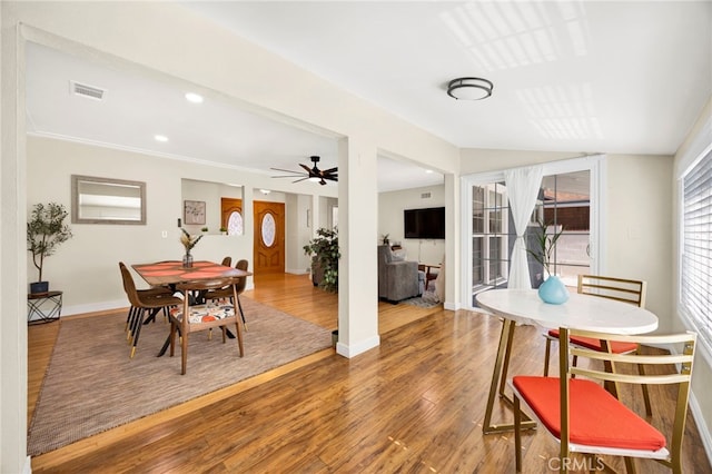 dining area featuring a ceiling fan, baseboards, visible vents, and wood finished floors