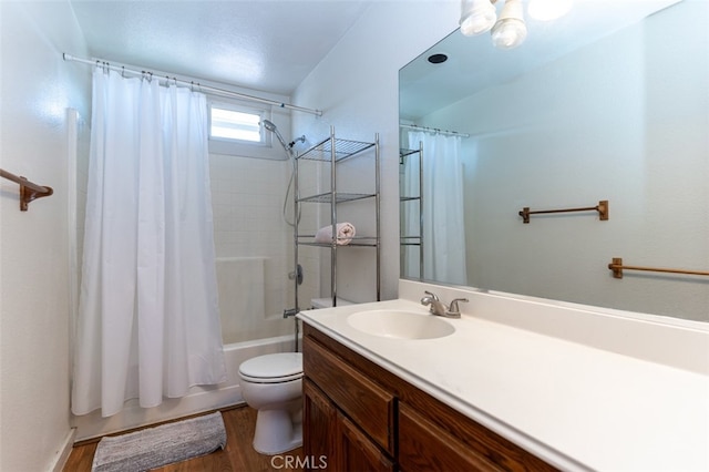 bathroom with toilet, shower / bath combo with shower curtain, and vanity