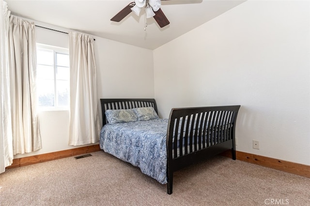 bedroom featuring visible vents, ceiling fan, light carpet, and baseboards