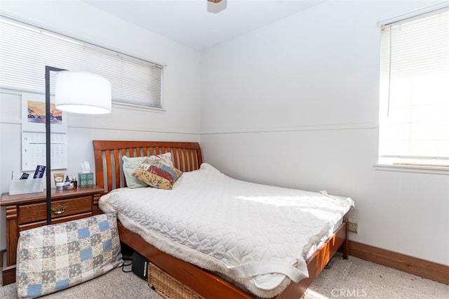 bedroom featuring ceiling fan and baseboards