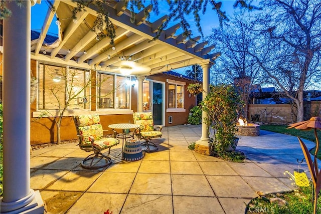 view of patio featuring an outdoor fire pit, fence, and a pergola