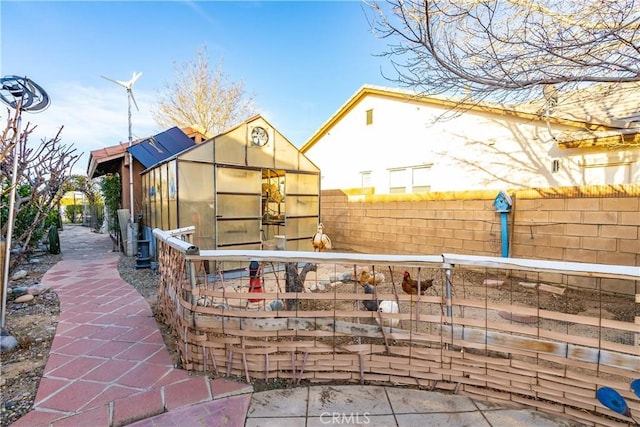 exterior space with an outbuilding and a fenced backyard