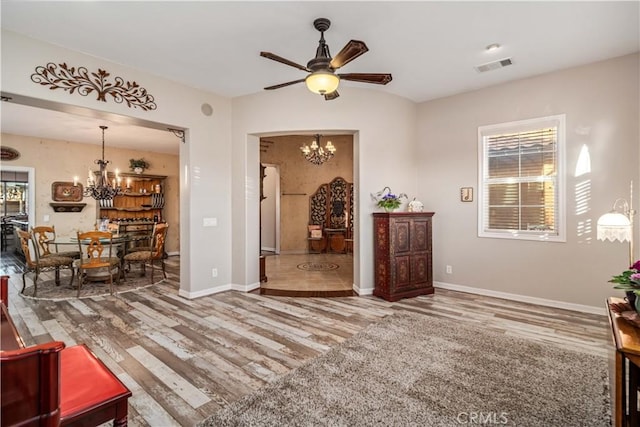 interior space with visible vents, baseboards, and wood finished floors