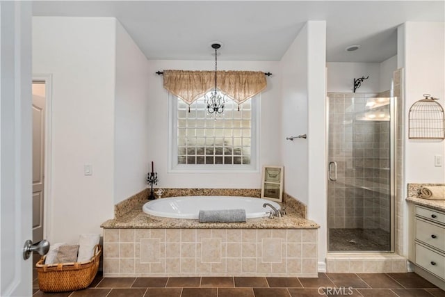 full bathroom featuring a garden tub, a notable chandelier, vanity, tile patterned floors, and a stall shower