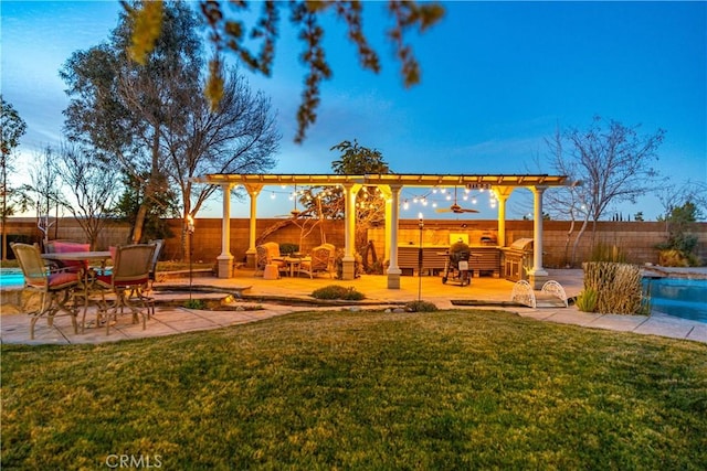 view of yard featuring ceiling fan, a patio area, a fenced backyard, and a fenced in pool