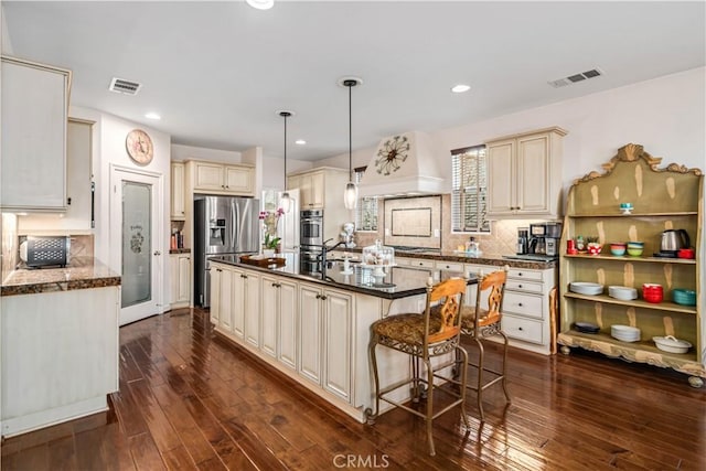 kitchen featuring a center island, cream cabinetry, decorative light fixtures, custom exhaust hood, and stainless steel fridge with ice dispenser