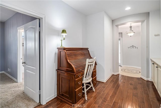 corridor featuring dark wood-style flooring, recessed lighting, and baseboards