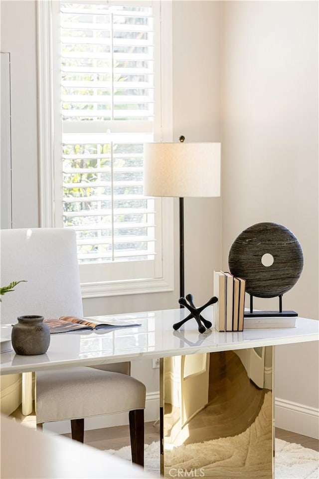 interior space featuring wood finished floors and baseboards