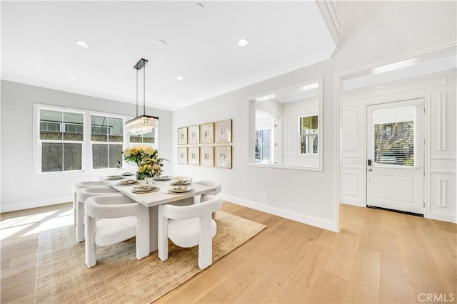 dining room with ornamental molding, recessed lighting, light wood-style floors, and baseboards