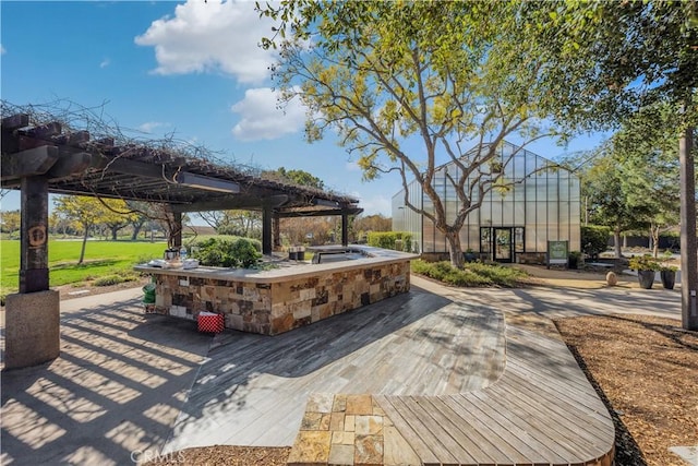 view of property's community featuring a deck and a bar