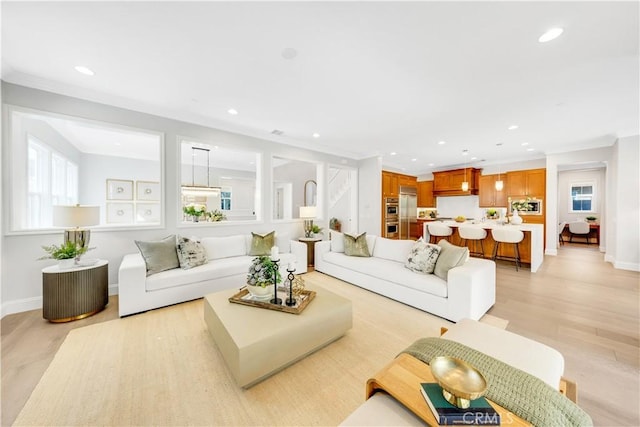 living room featuring light wood-style floors, baseboards, and recessed lighting