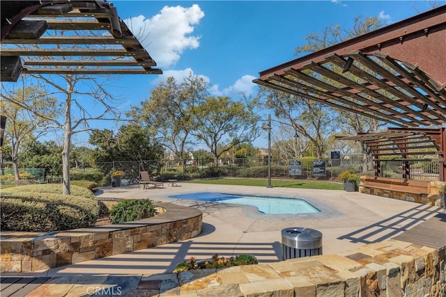 outdoor pool with a patio, a jacuzzi, and fence