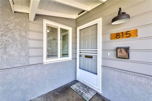 entrance to property with stucco siding