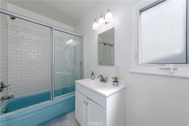 bathroom featuring bath / shower combo with glass door and vanity