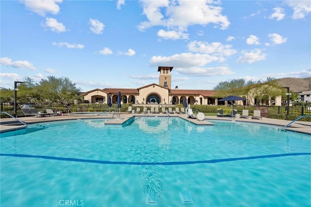 pool featuring fence and a patio