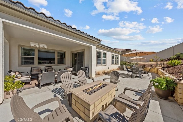 view of patio / terrace with an outdoor fire pit and fence