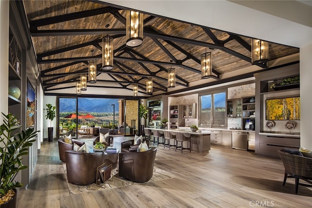 interior space featuring lofted ceiling with beams, plenty of natural light, wood ceiling, and a chandelier