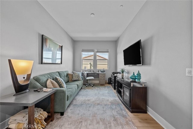 living room with light wood-style flooring and baseboards