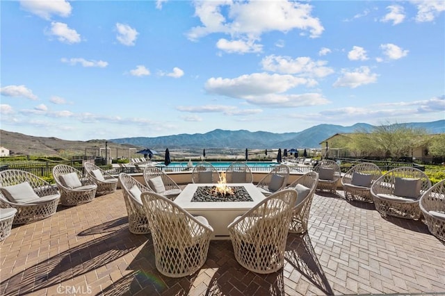 view of patio featuring a fire pit and a water and mountain view