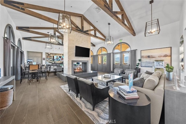 living area featuring an inviting chandelier, wood finished floors, and a multi sided fireplace