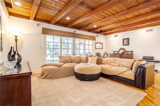 living room featuring visible vents, wooden ceiling, light wood-style flooring, beamed ceiling, and french doors