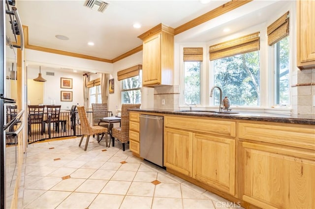 kitchen with light tile patterned flooring, light brown cabinets, stainless steel appliances, a sink, and visible vents